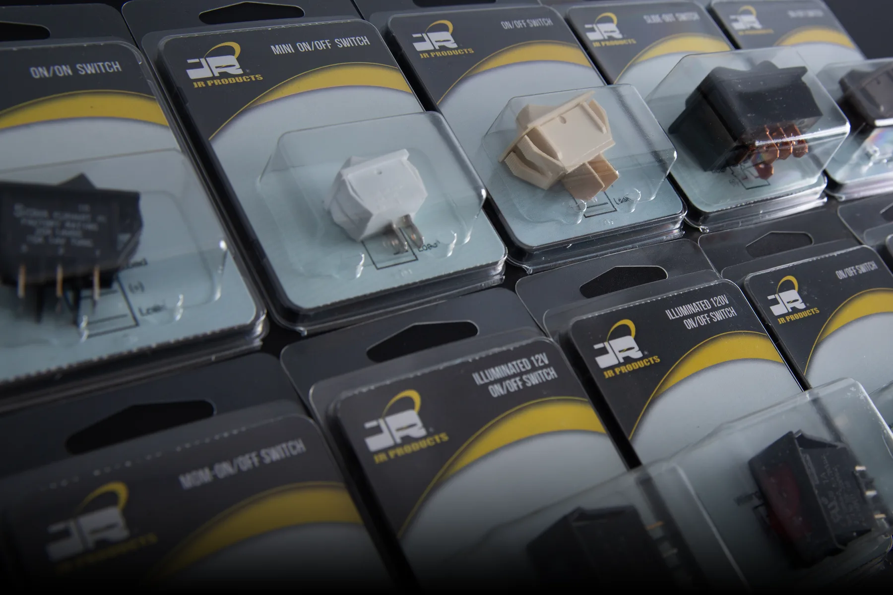 JR Products packaged electrical switches and connectors displayed as a retail assortment