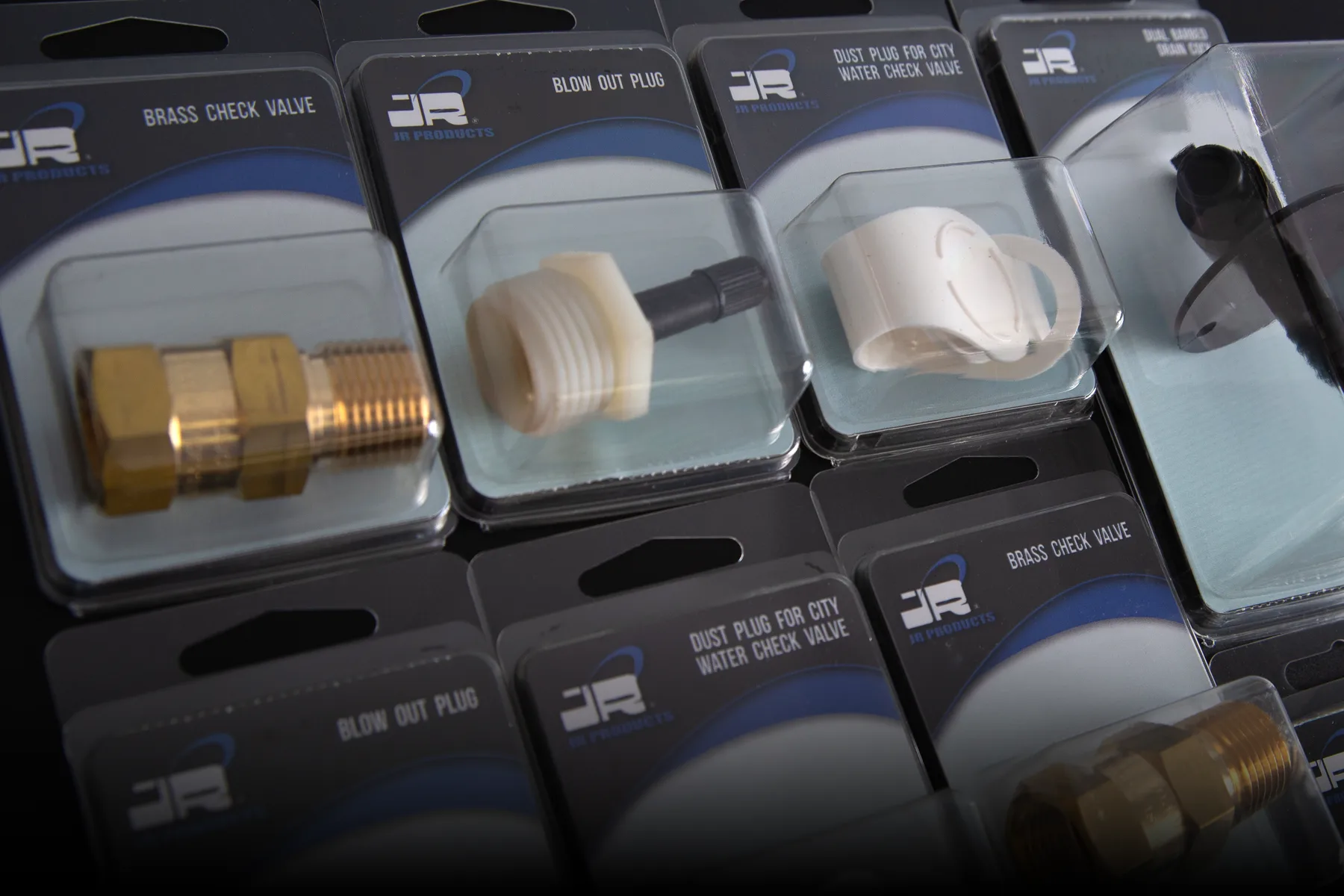 JR Products packaged plumbing valves and fittings displayed as a retail assortment
